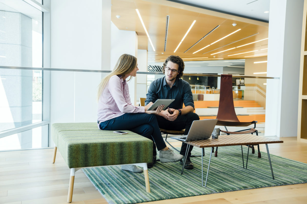 Diverse group of coworkers meeting in modern office space